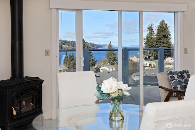 interior space featuring a wood stove and a water view