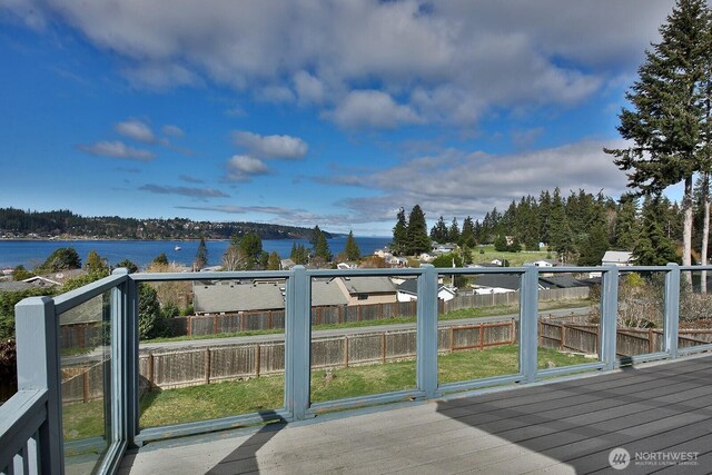 wooden deck featuring fence and a water view