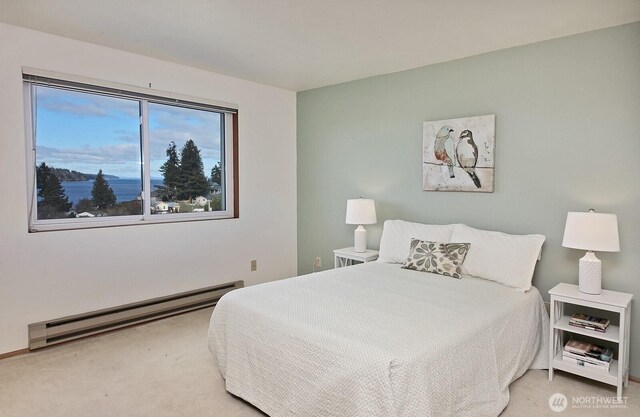 carpeted bedroom with baseboard heating