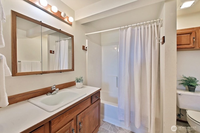 full bath featuring vanity, toilet, and shower / bath combo with shower curtain