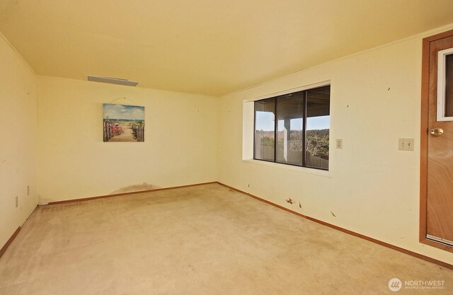 unfurnished room with visible vents, baseboards, and carpet