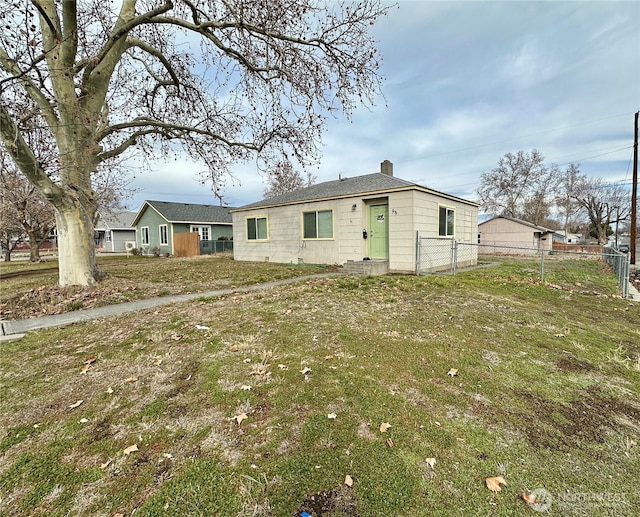 view of front of property with a front yard, fence, and a chimney