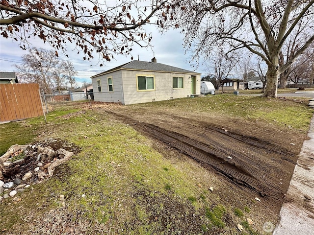 view of property exterior with fence