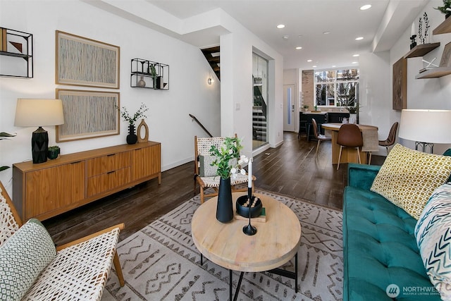 living area featuring baseboards, dark wood finished floors, and recessed lighting