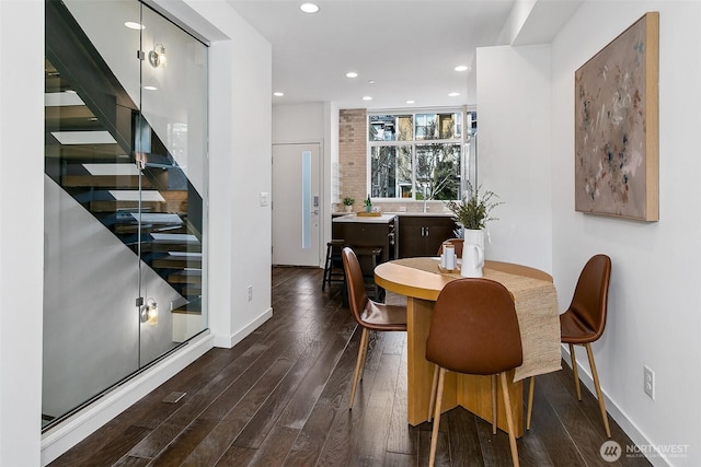 dining room featuring stairs, baseboards, dark wood-type flooring, and recessed lighting