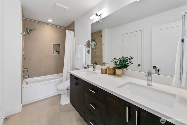 bathroom with toilet, double vanity, shower / bath combo, and a sink