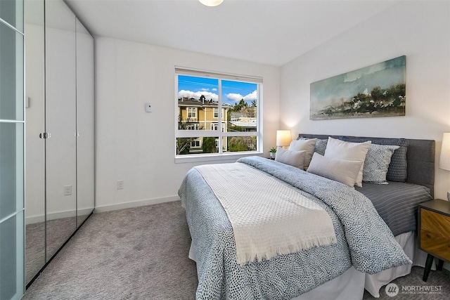 bedroom with light carpet and baseboards