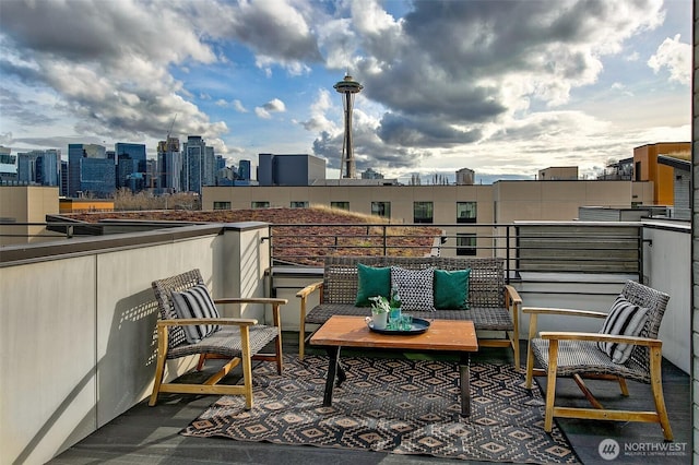 balcony featuring an outdoor living space and a city view