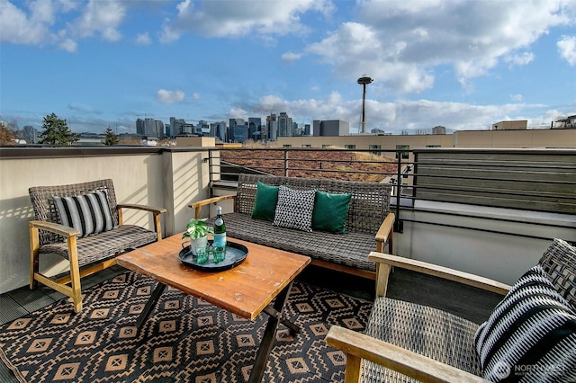 view of patio featuring a city view, outdoor lounge area, and a balcony