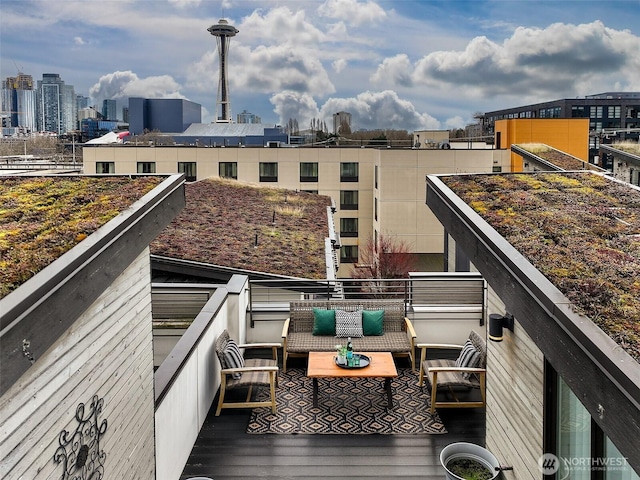 balcony with outdoor lounge area and a city view