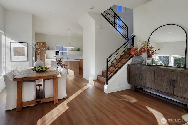 entrance foyer featuring stairway, baseboards, and wood finished floors