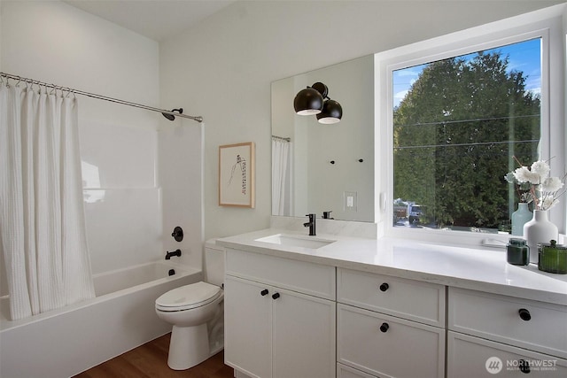 bathroom with shower / bath combination with curtain, vanity, toilet, and wood finished floors