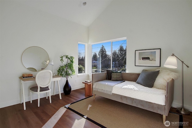 living room with wood finished floors, baseboards, and high vaulted ceiling