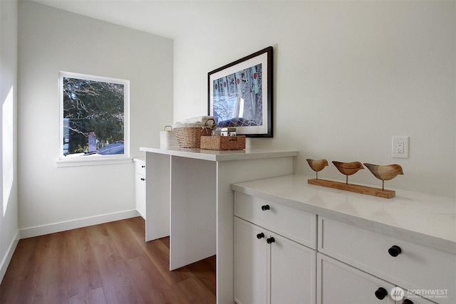 room details with baseboards and wood finished floors