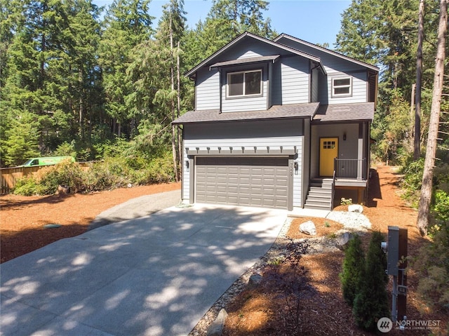 traditional home featuring driveway, a shingled roof, and a garage