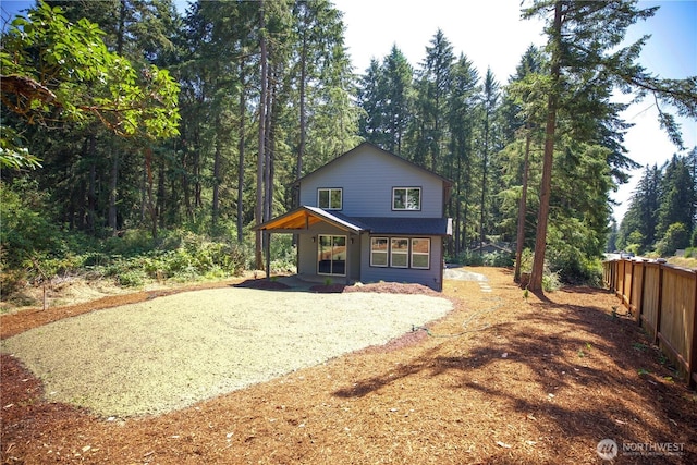 view of front of property with a porch and gravel driveway