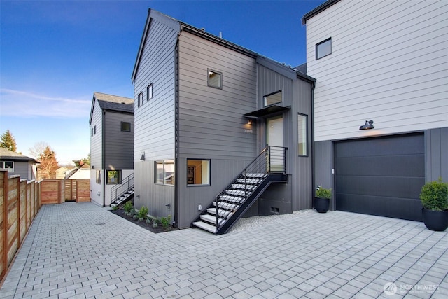 view of front of home featuring a garage and fence