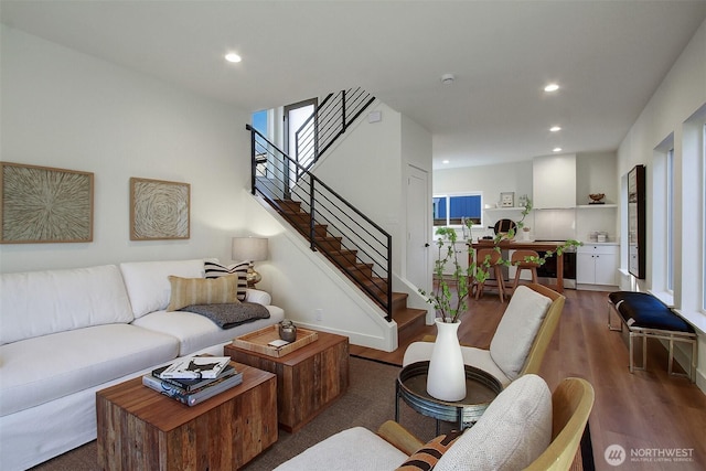 living room with stairs, recessed lighting, and wood finished floors