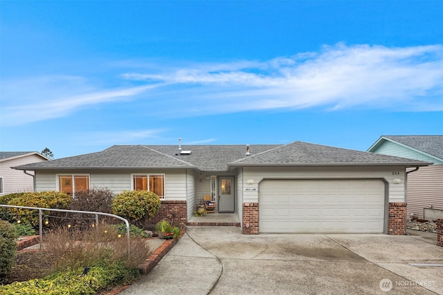 ranch-style home with brick siding, driveway, an attached garage, and roof with shingles