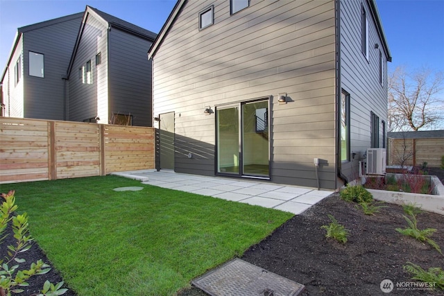 back of house featuring a yard, a patio, central AC unit, and fence