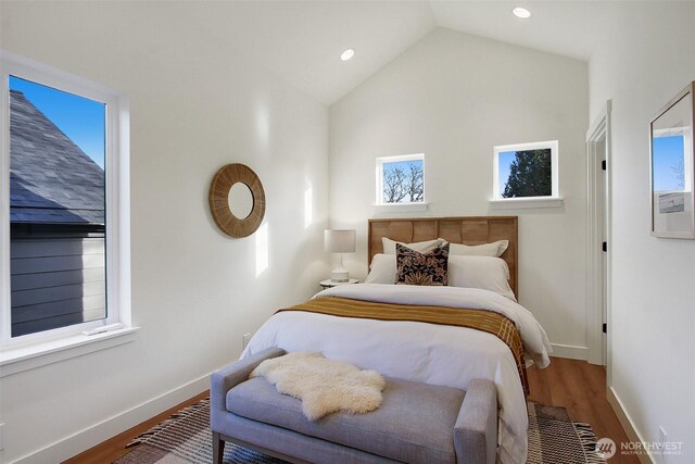 bedroom with vaulted ceiling, recessed lighting, wood finished floors, and baseboards