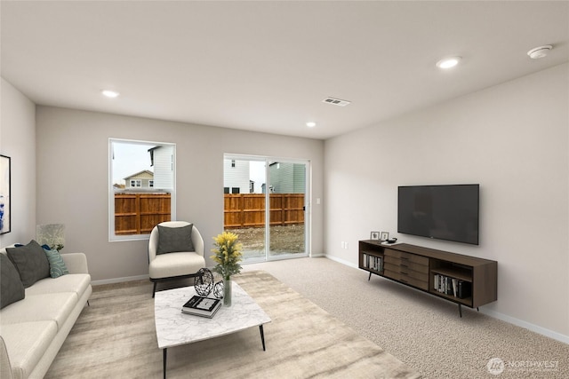 living area featuring recessed lighting, baseboards, visible vents, and carpet flooring