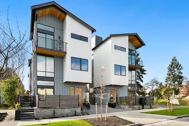 modern home with board and batten siding and a balcony