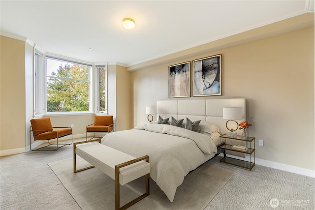carpeted bedroom with baseboards and ornamental molding