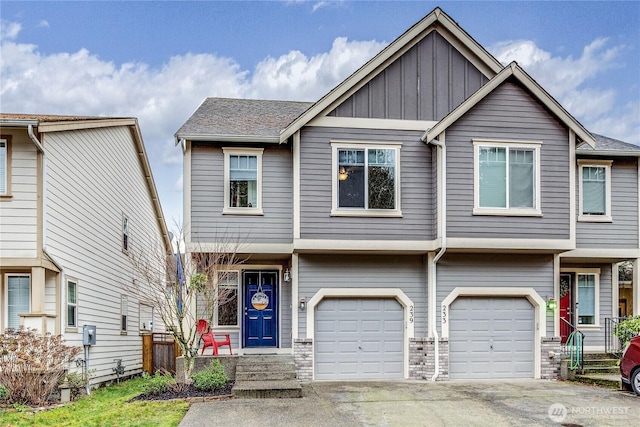 view of property with a garage, concrete driveway, and board and batten siding