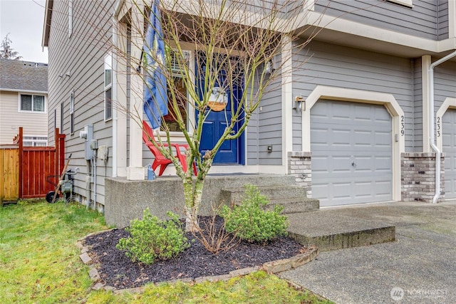 property entrance featuring a garage and fence