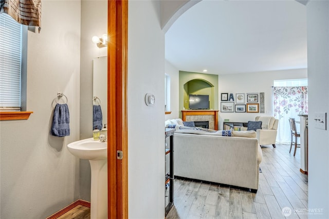 bathroom featuring a fireplace and wood finished floors