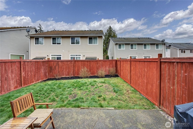 view of yard with a fenced backyard and a residential view