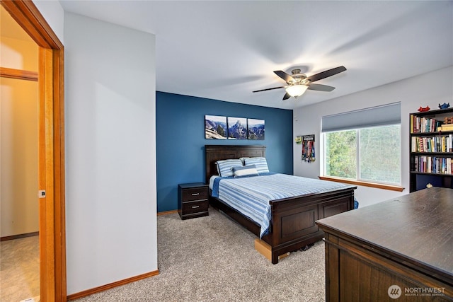 bedroom featuring ceiling fan, baseboards, and light colored carpet