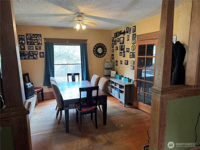 4700 Delta Ln SE, Tumwater, WA 98501 - dining area featuring a textured ceiling, a ceiling fan, and wood-type flooring