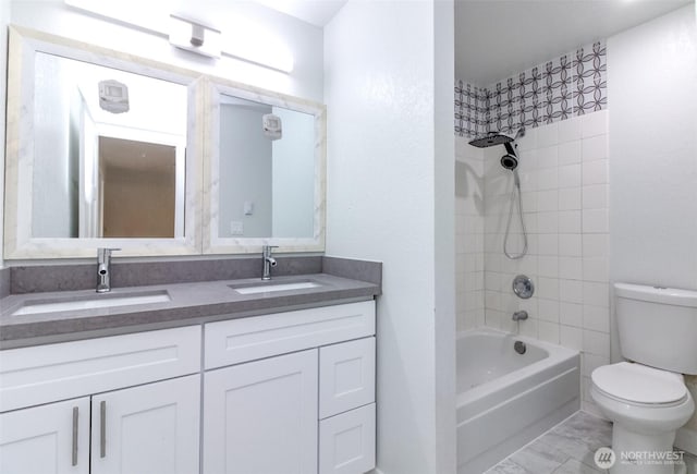 full bath with double vanity, tub / shower combination, toilet, and a sink