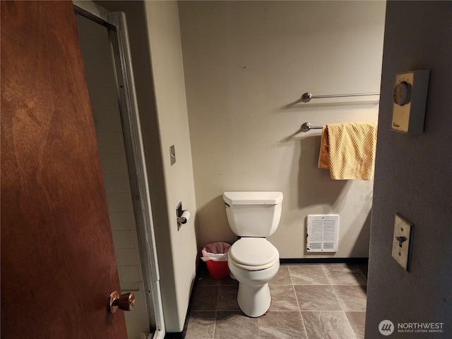 bathroom with baseboards, a shower with shower door, visible vents, and toilet