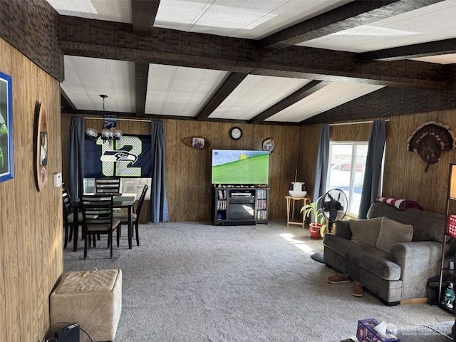 carpeted living room with vaulted ceiling with beams, wood walls, and an inviting chandelier