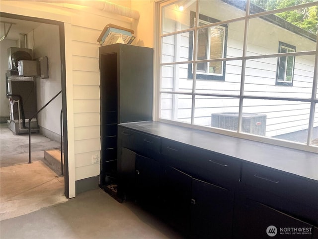 interior space featuring concrete floors and cooling unit