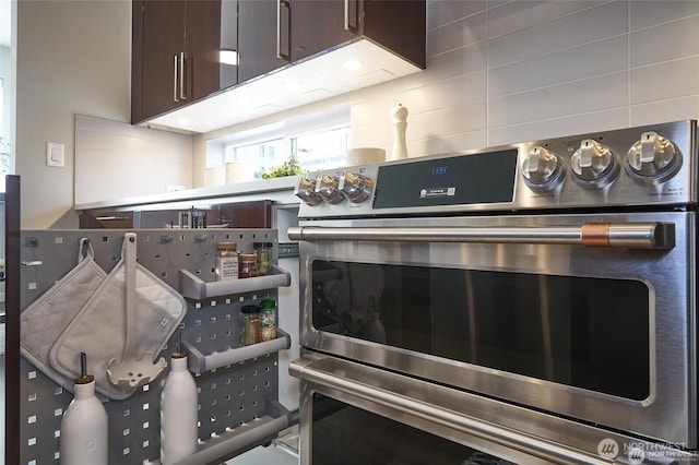 interior details with tasteful backsplash, dark brown cabinets, and double oven