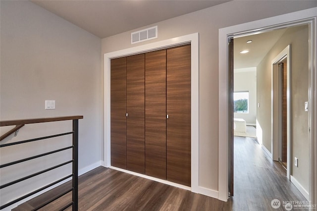 interior space featuring visible vents, recessed lighting, a closet, baseboards, and dark wood-style flooring