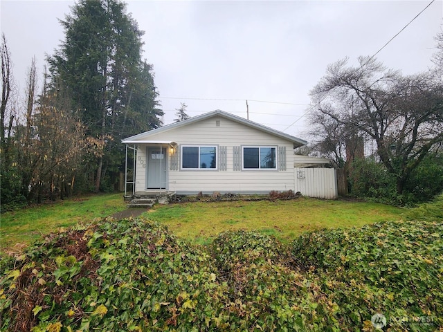 bungalow-style home featuring a front lawn