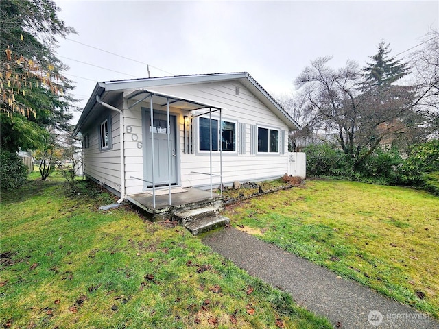 bungalow-style house featuring a front yard