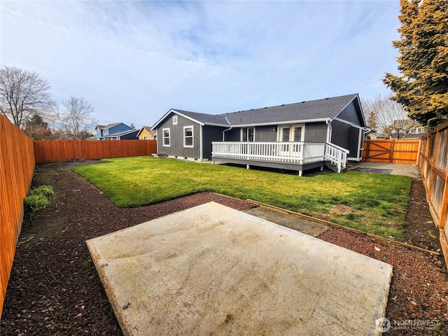 rear view of house featuring a patio area, a fenced backyard, a deck, and a lawn