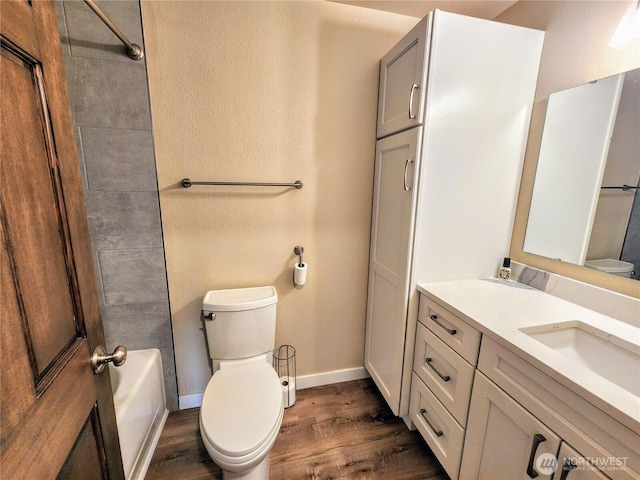 full bathroom with vanity, toilet, and wood finished floors