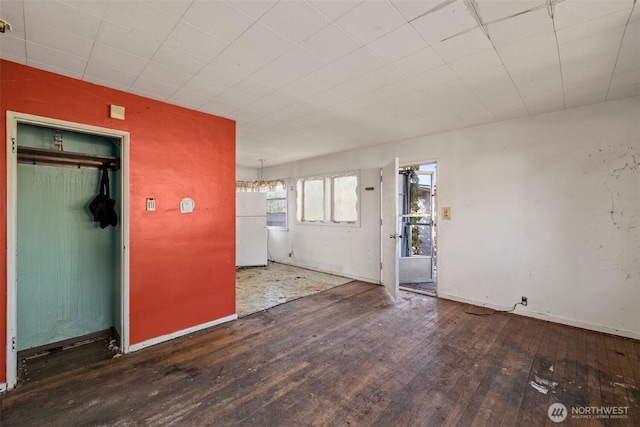 interior space featuring wood-type flooring and baseboards