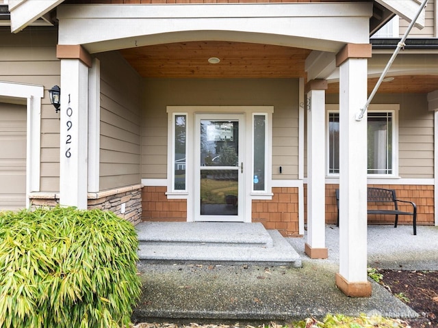 doorway to property featuring covered porch