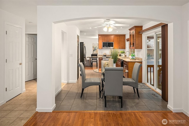 dining room featuring a ceiling fan, visible vents, baseboards, recessed lighting, and dark tile patterned floors