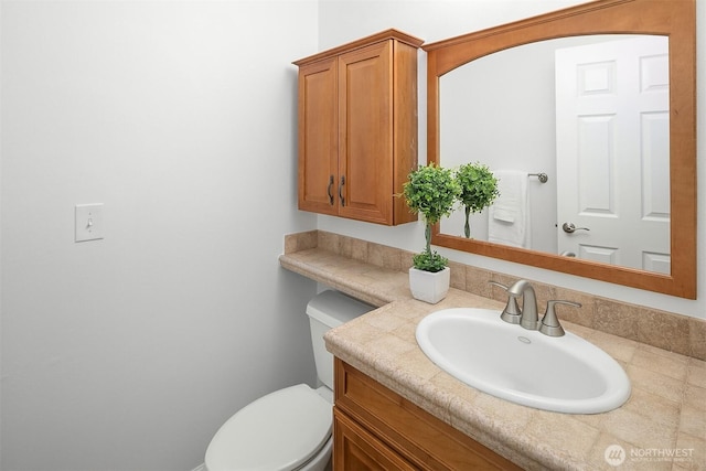 bathroom featuring vanity and toilet