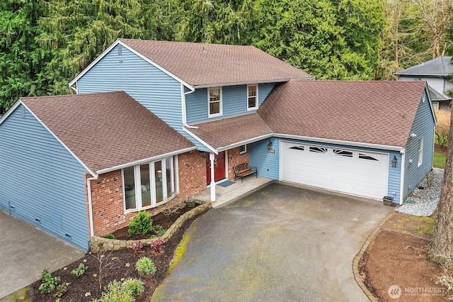 traditional-style home with aphalt driveway, brick siding, an attached garage, and a shingled roof