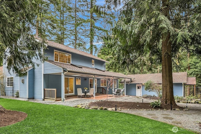 back of house with a patio and a yard